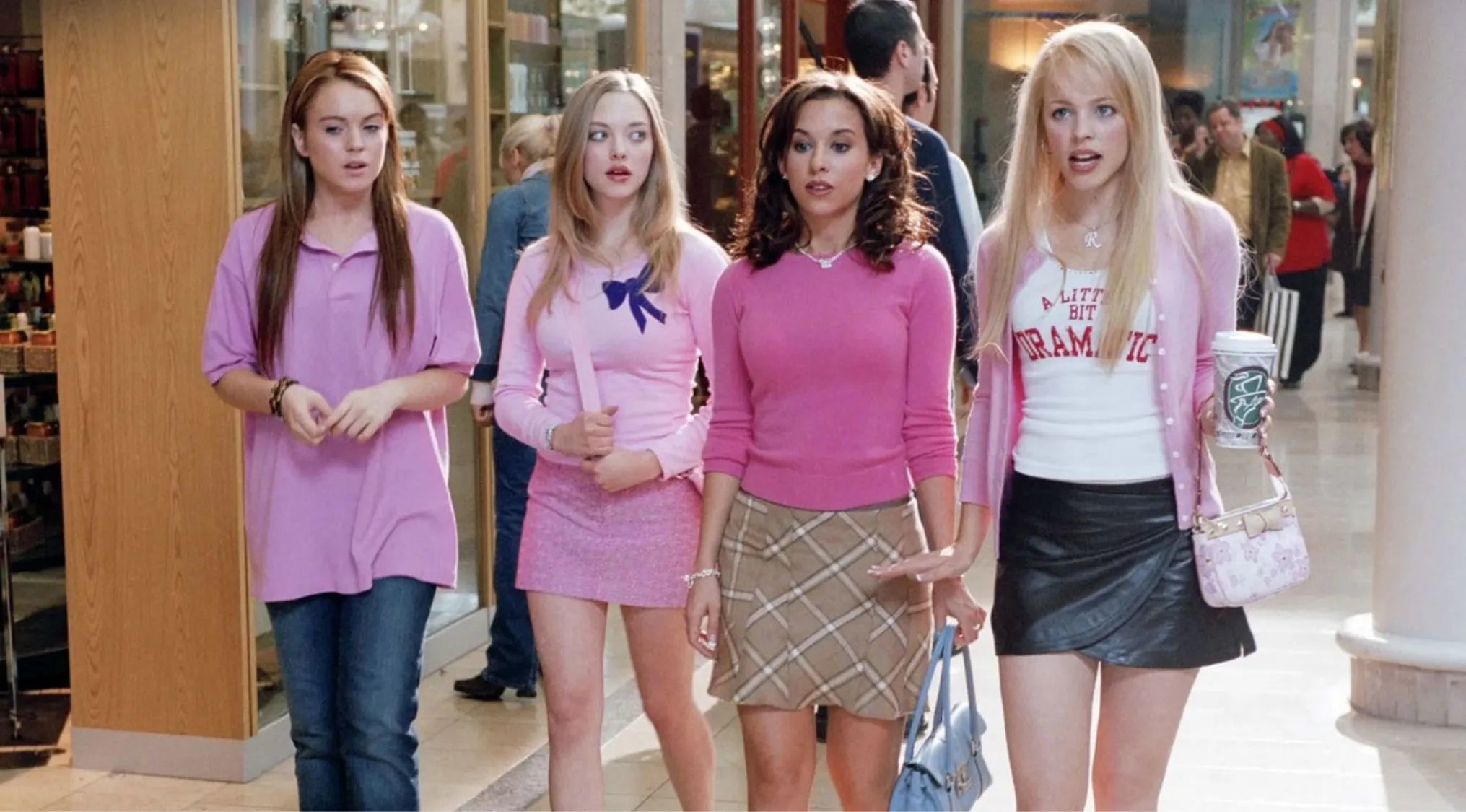 Scene from Mean Girls showing four young women walking in a mall, highlighting side character Gretchen Wieners and fashion styles.