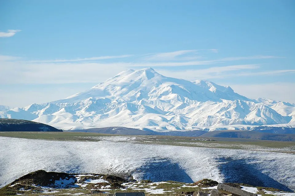 Snow-covered Mount Elbrus towering over the landscape, illustrating the highest mountain in Europe geography question.