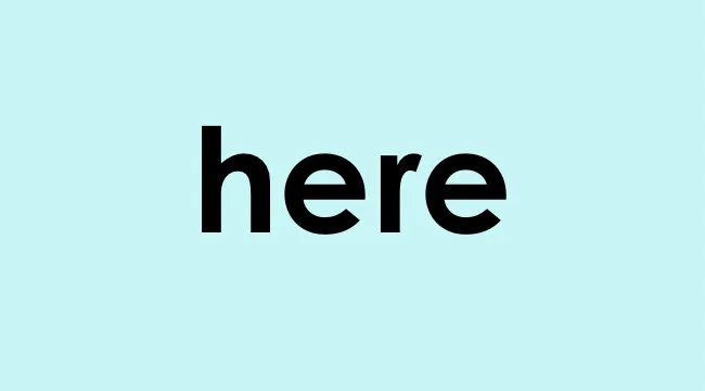 The word here displayed in bold black text on a light blue background for homophone choice practice.