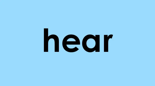 The word hear in bold black letters on a light blue background representing homophone choice.