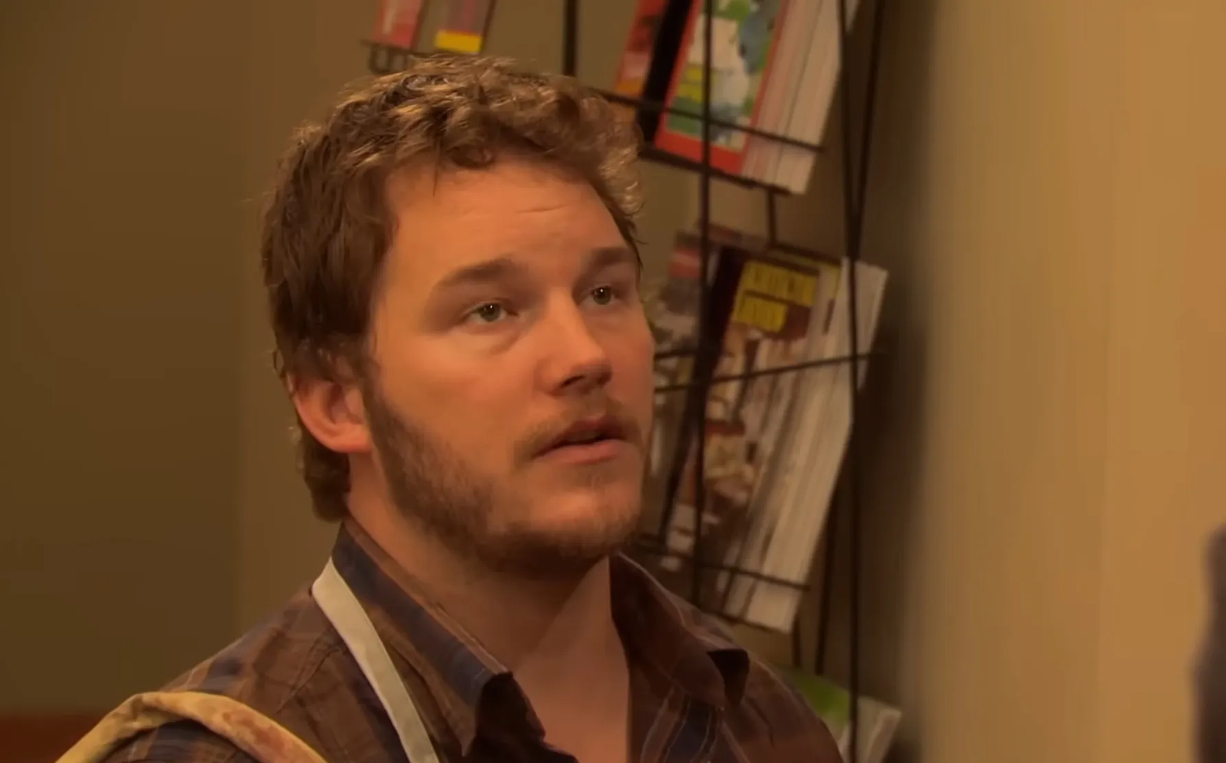 Actor portraying Andy Dwyer in Parks and Recreation, side character known for his casual plaid shirt and apron.