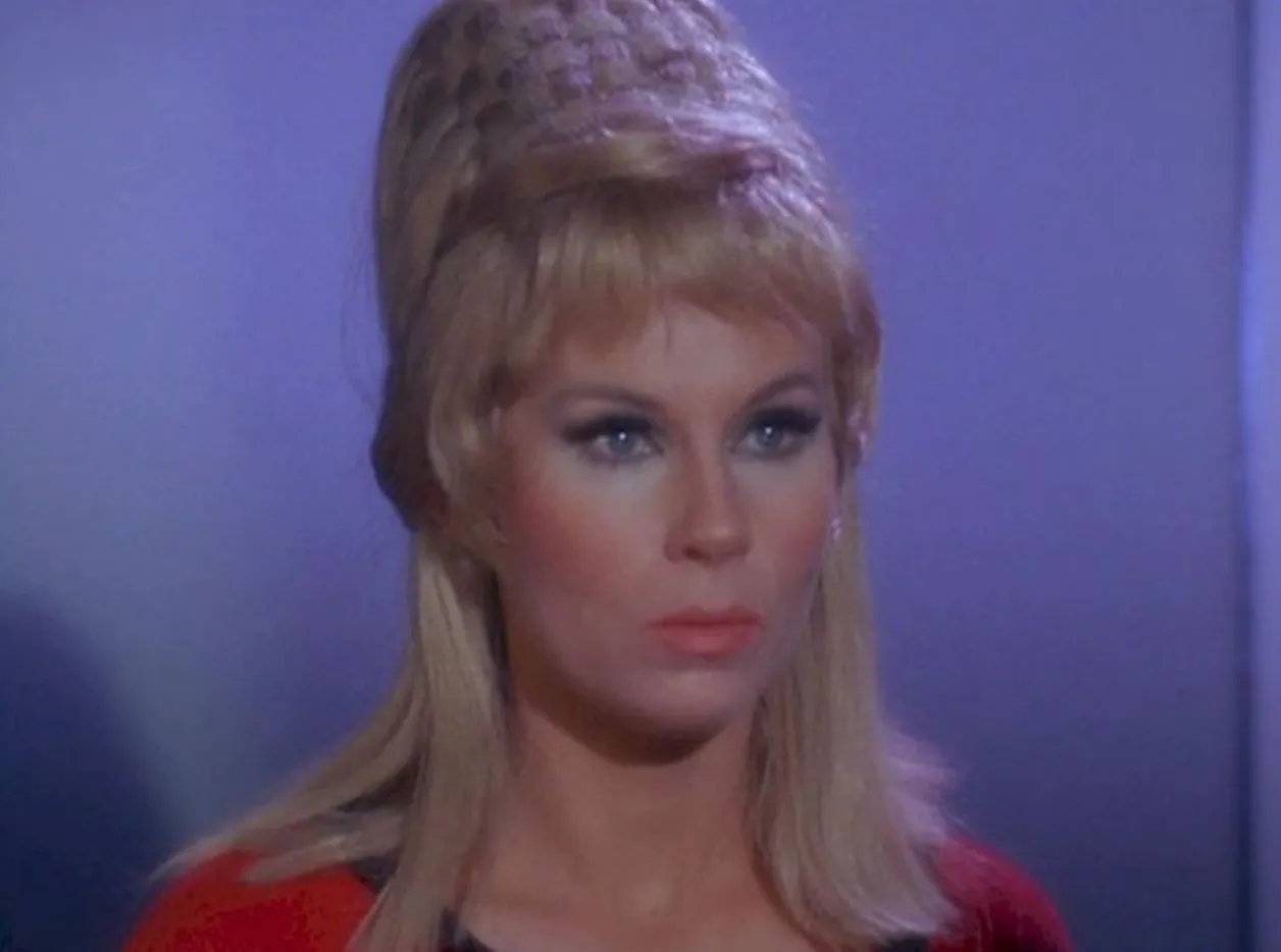 Blonde woman with styled hair and blue eye makeup, portraying Christine Chapel from Star Trek The Original Series.