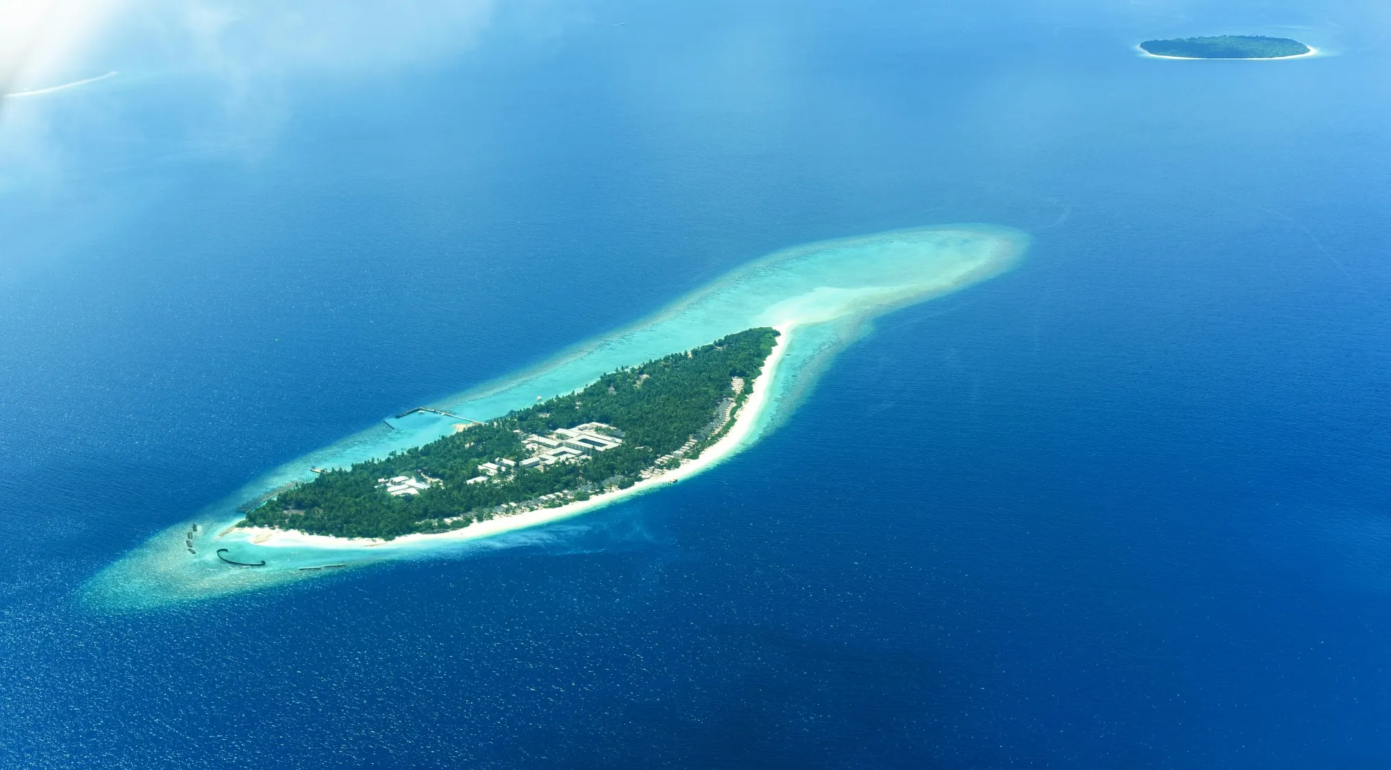 Aerial view of a tropical island surrounded by blue ocean, representing countries with capitals on an island in geography quiz.