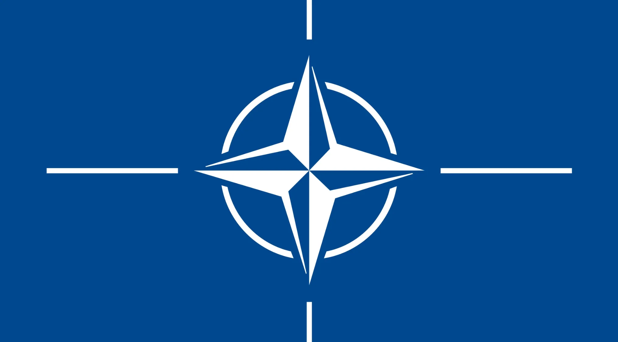 NATO emblem on blue background representing countries that are members in a geography quiz context.