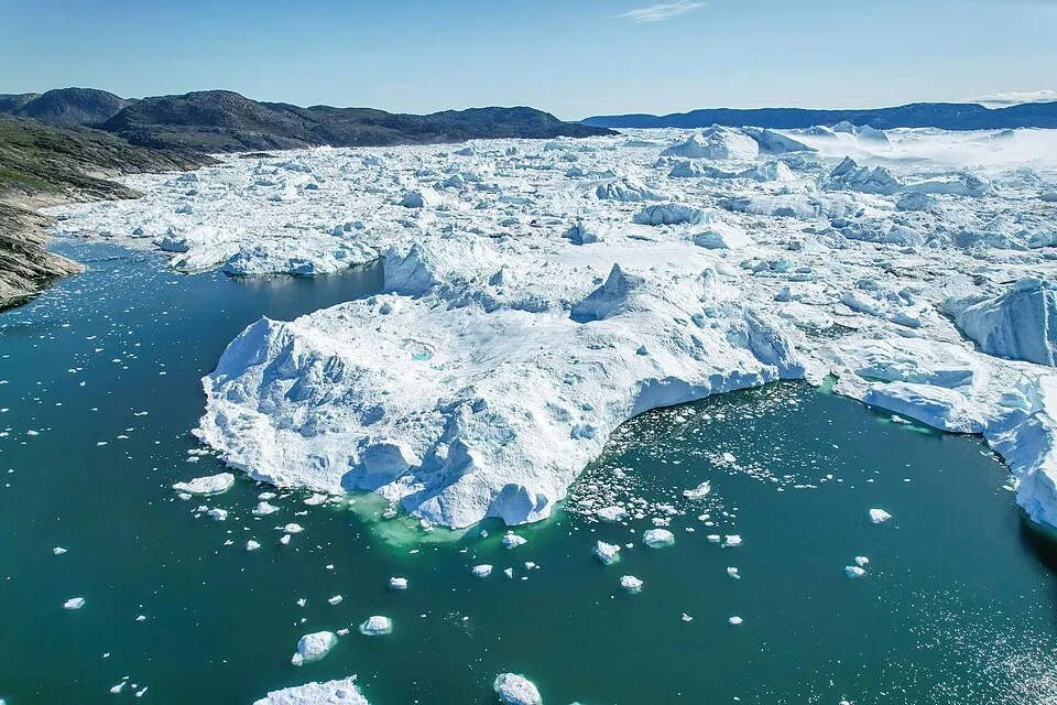 Aerial view of Greenland icebergs and icy waters highlighting geography true-or-false questions about its continent status.