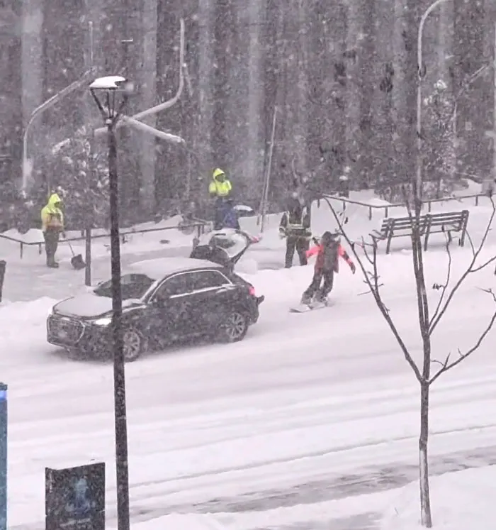 Snowstorm hitting the U.S. as people navigate heavy snow on roads and sidewalks in winter conditions.