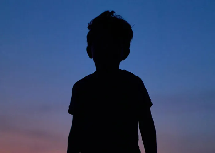 Silhouette of a child at dusk representing kids with no filter revealing unexpected family lore stories.