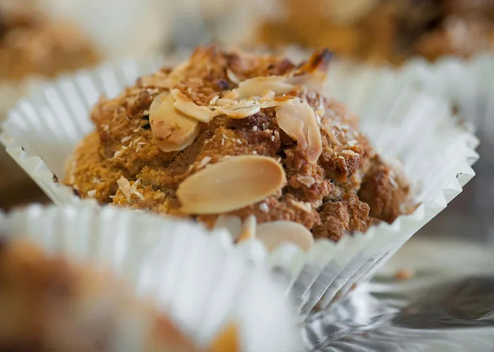 Close-up of a muffin topped with sliced almonds, highlighting textures related to medical issues and health concerns.