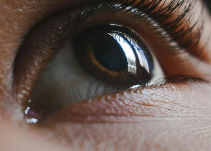 Close-up of a human eye highlighting details related to medical issues and health conditions affecting vision and skin.