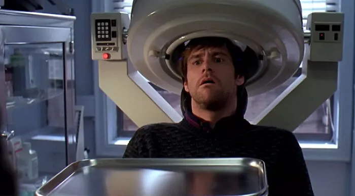 Would You Rather man with shocked face under a medical scanner and metal tray in a clinical room
