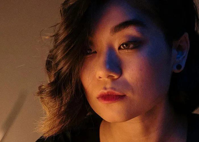 Close-up of a thoughtful young woman reflecting on life changes after learning she wasn’t the biological parent.