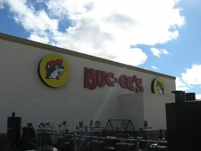 Buc-ee's storefront with mascot logo under a cloudy sky, an example of disappointing tourist attractions locals debate.