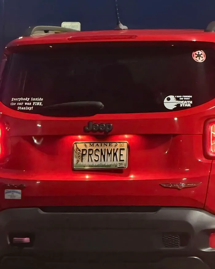 Red Jeep with The Office inspired stickers, including a Stanley quote and Death Star decal on the rear window.