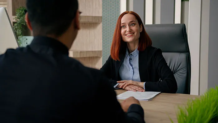 Recruiter interviewing a job candidate in a modern office, discussing how candidates lose chances of getting the job.