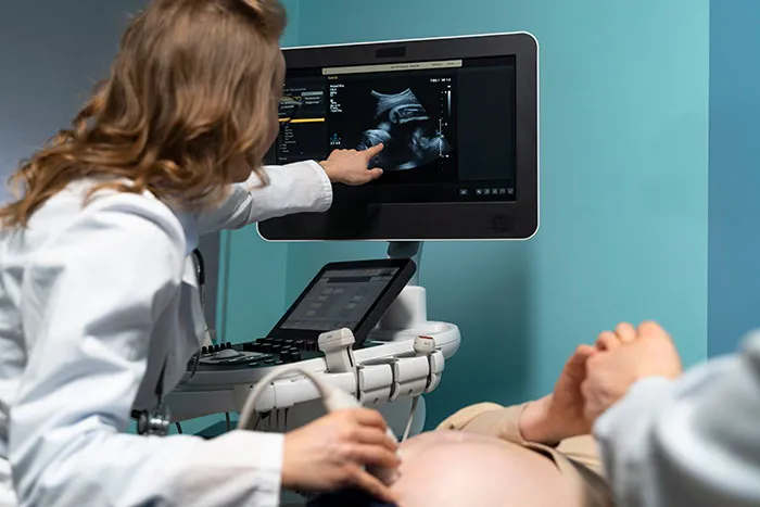 Doctor performing ultrasound scan on pregnant woman, highlighting things about men women often want to understand.