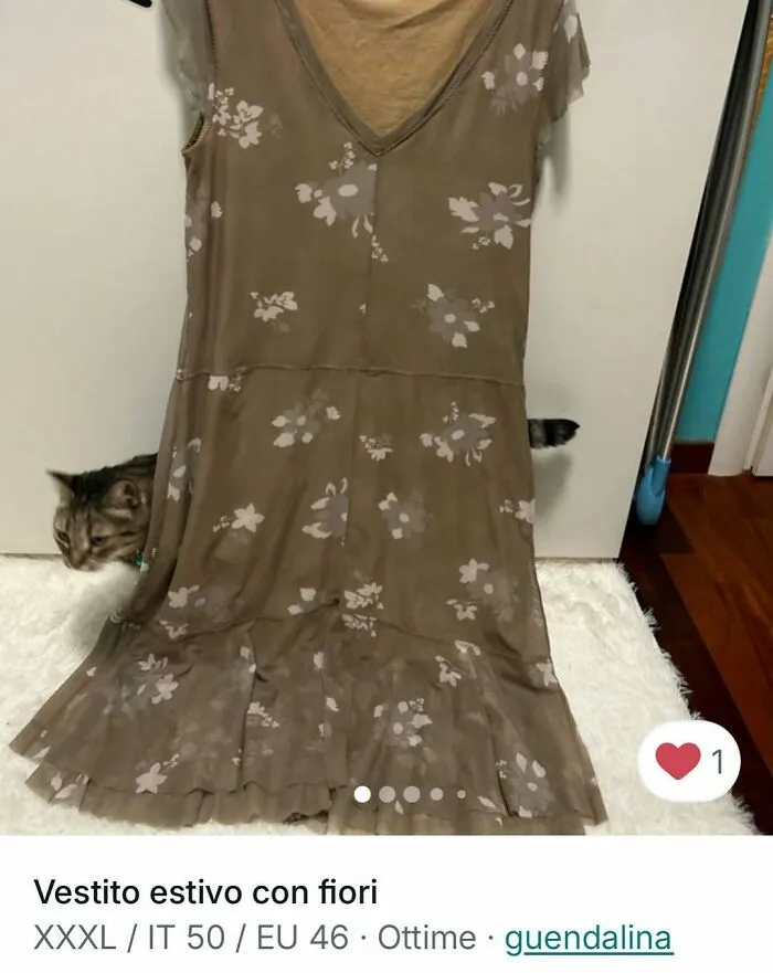 Cat peeking from behind a floral summer dress in a Vinted ad, perfectly stealing the spotlight.