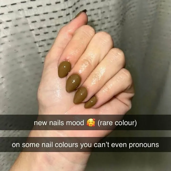 Close-up of hand with bizarre olive green nails, fitting the theme of random and bizarre memes that provoke curiosity.