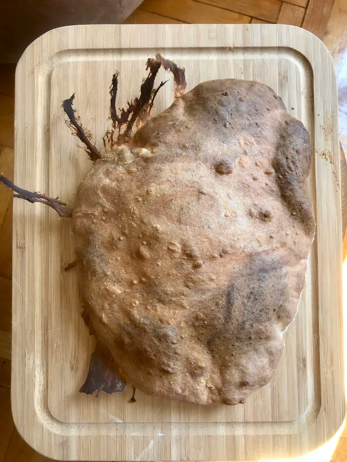 Overcooked and burnt dessert on wooden board showing unexpected dessert ruin mishap.