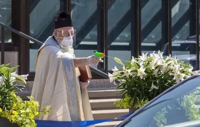 A Priest Giving Social Distance Blessings With A Squirt Pistol And What, I'm Assuming, Is Holy Water. 2020 Folks