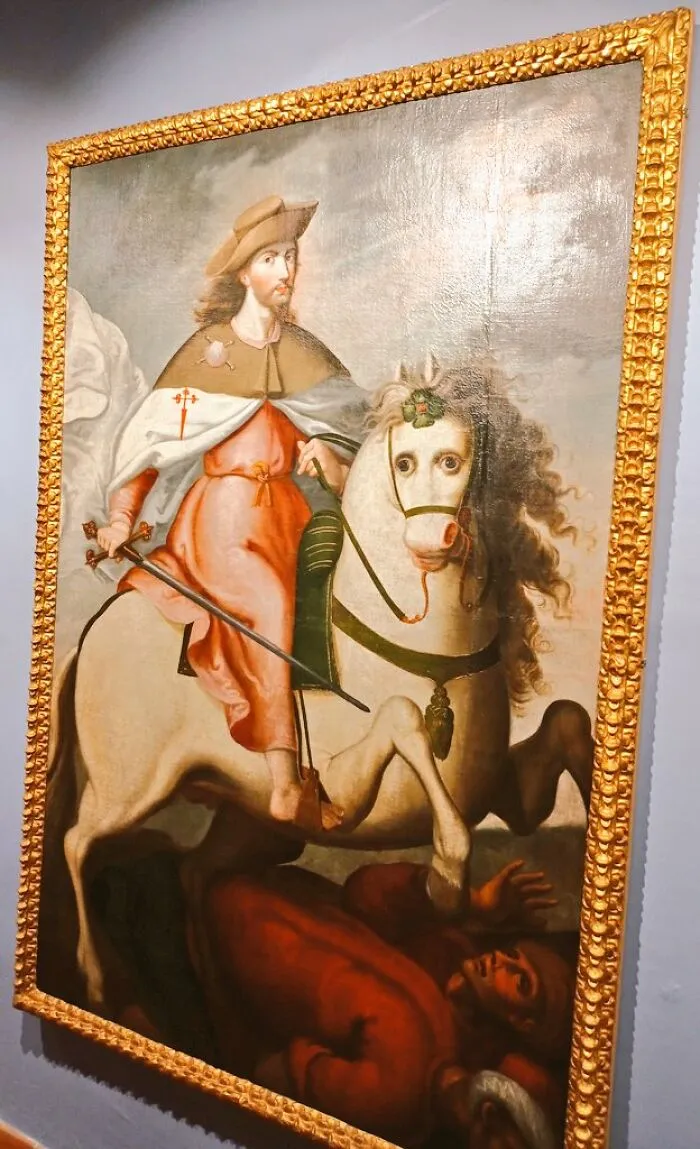 Old painting of a knight on a horse with exaggerated features, showcasing hilariously bad but brilliant art style.