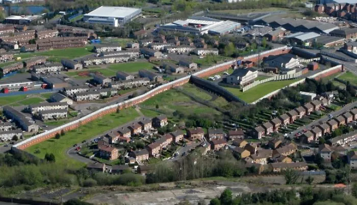 Aerial view of a suburban area with residential houses and industrial buildings representing disappointing tourist attractions.