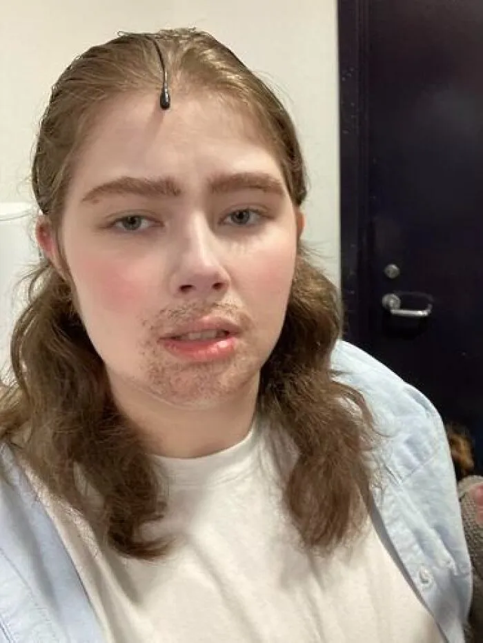 Person with stage makeup resembling facial hair and a subtle mustache, showcasing magical and mildly cursed makeup looks.