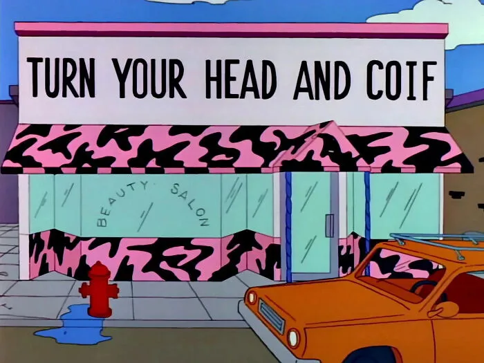 The Simpsons scene showing a humorously misspelled beauty salon sign from the best signs collection