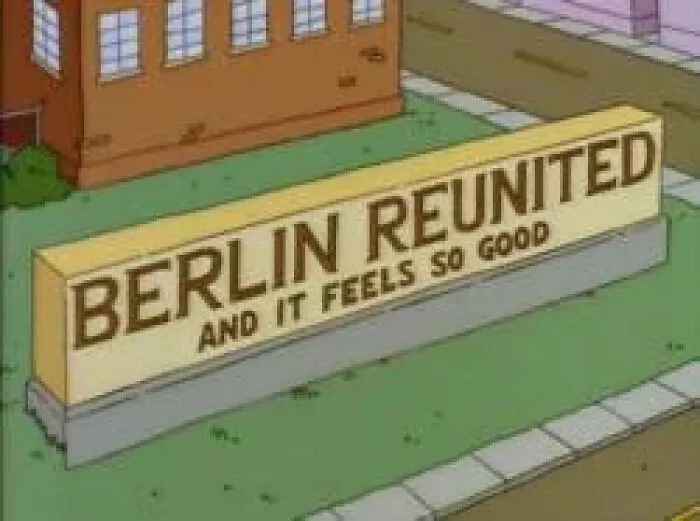 Simpsons sign reading Berlin reunited and it feels so good displayed outside a building in animated style