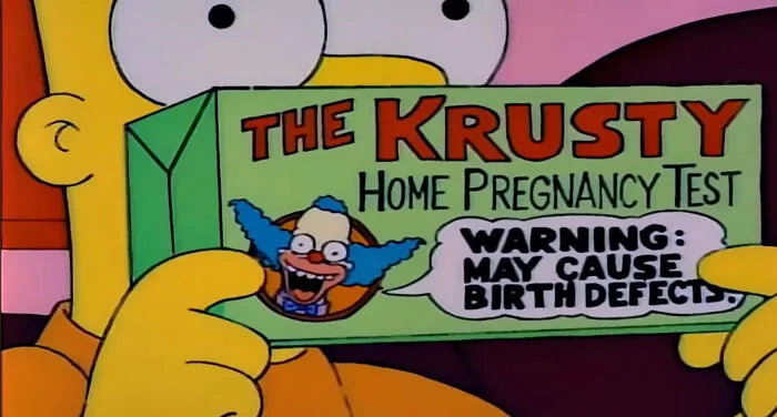Bart Simpson holding a Krusty home pregnancy test box with a humorous warning sign from The Simpsons.