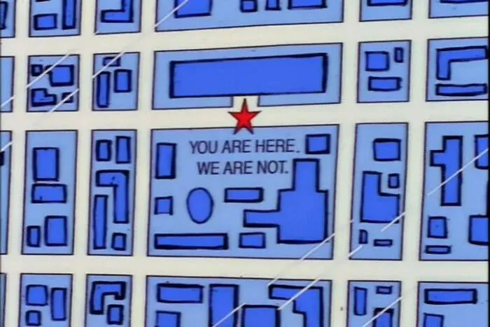 Map from The Simpsons with a red star and the best signs including the message you are here we are not.