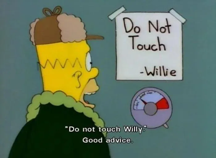 Homer Simpson looking at a humorous warning sign in The Simpsons featuring the best signs from the show.