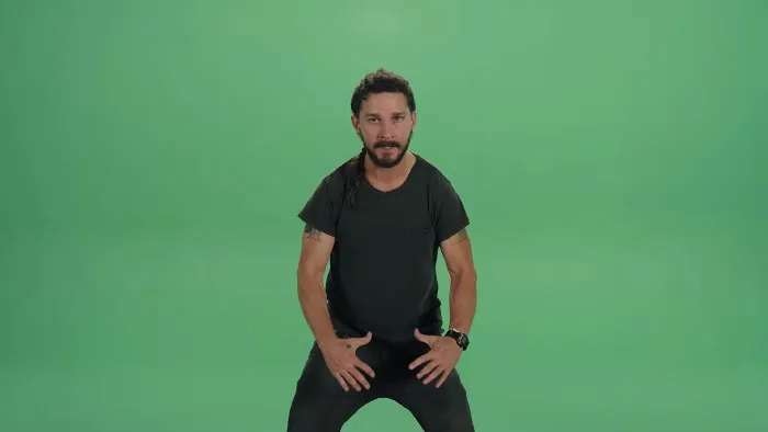 Man with braided hair and a beard, wearing a black t-shirt, posing against a green screen background expressing boomer opinions.
