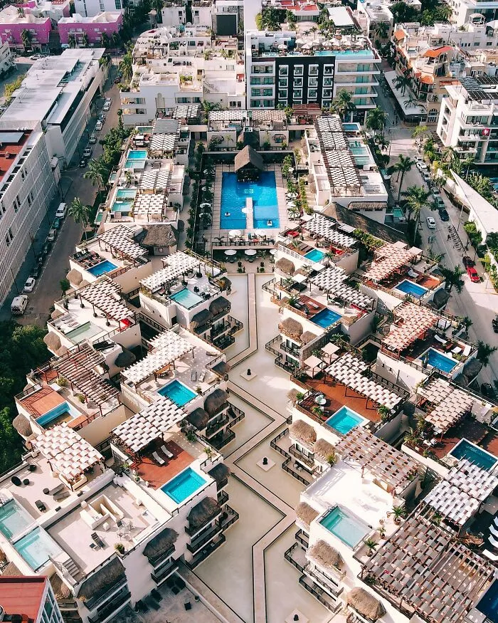 Aerial view of a resort with multiple pools and buildings, illustrating disappointing tourist attractions locals still don’t get.