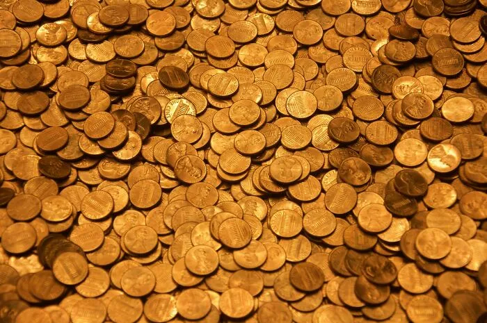 A large pile of pennies representing things normal in some countries but offensive elsewhere in cultural context.