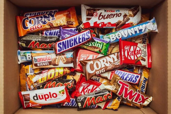 Box filled with various candy bars inside, unrelated to shipping containers or their common problems and solutions.