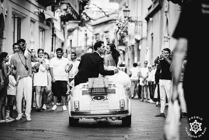 When Love Fits In A Tiny Car… And The Whole Town Shows Up To Watch.  Photo By Carmelo Ucchino