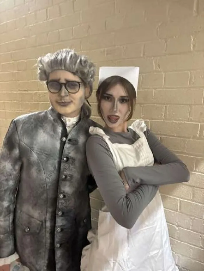 Two people in stage makeup posing, one in 18th-century costume and the other in a nurse outfit, showcasing stage makeup looks.