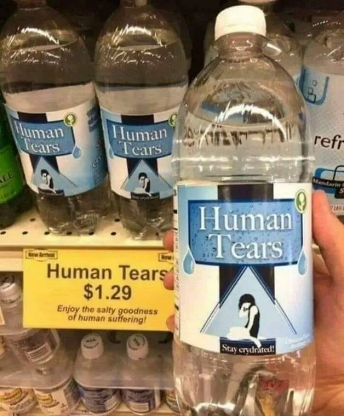 Bottles labeled Human Tears with a sign showing price $1.29, highlighting dystopia and human suffering concept.