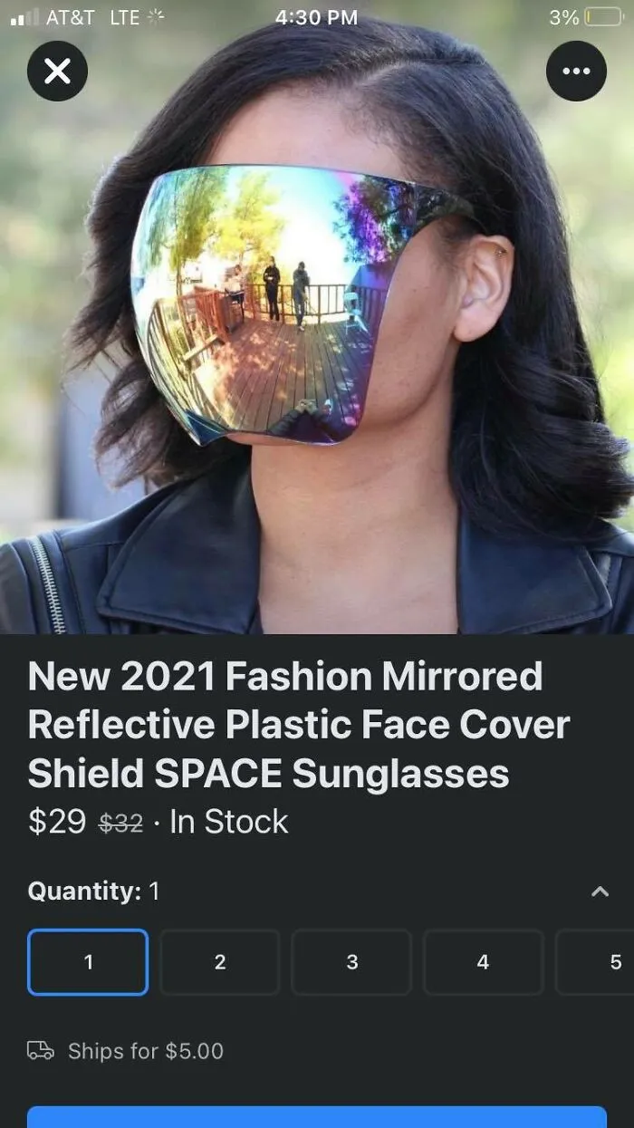 Person wearing a mirrored reflective plastic face cover shield outdoors, showcasing dystopia-themed futuristic fashion.
