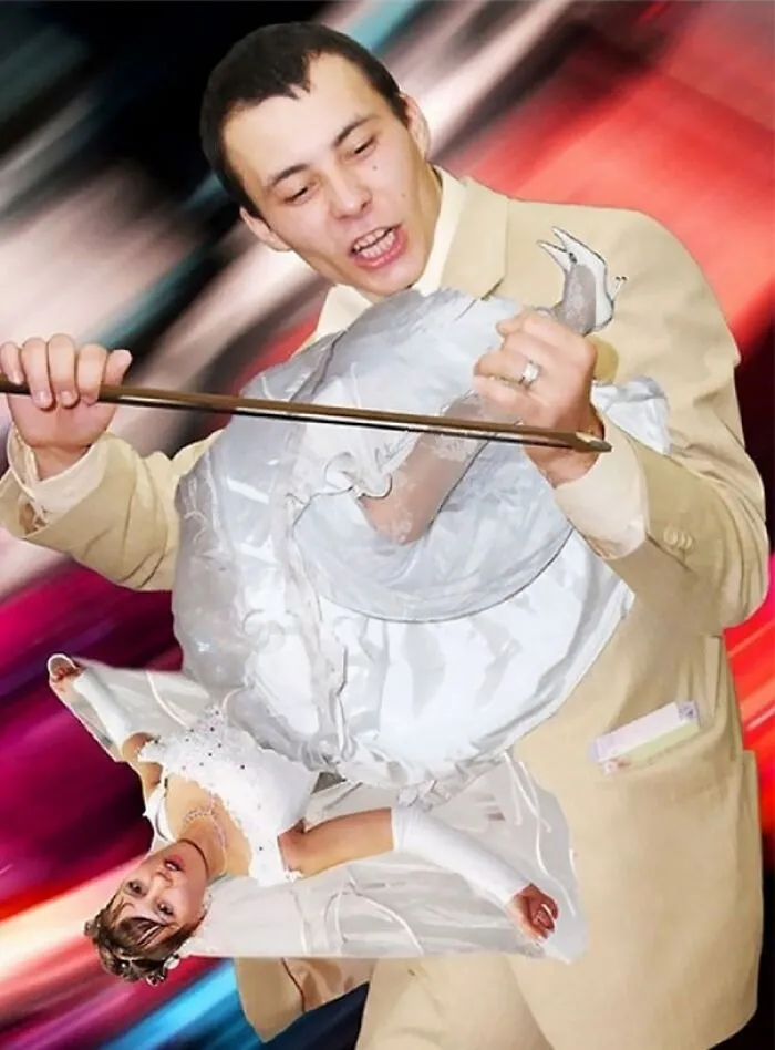 Man in beige suit holding a cutout bride doll awkwardly in a wedding setting with colorful blurred background.