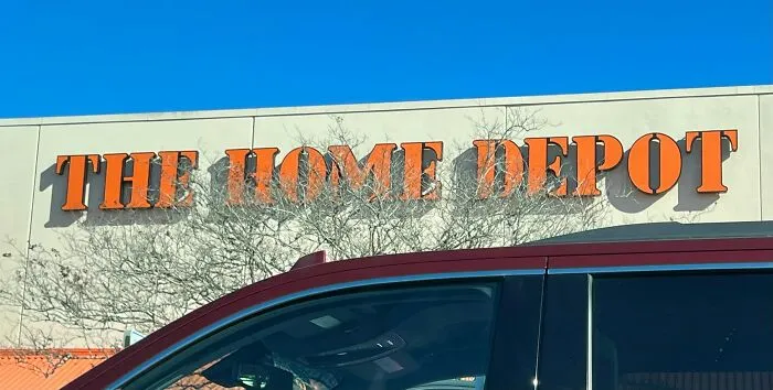 The Home Depot store exterior on a clear sunny day with a red vehicle parked in front, related to former cult members.