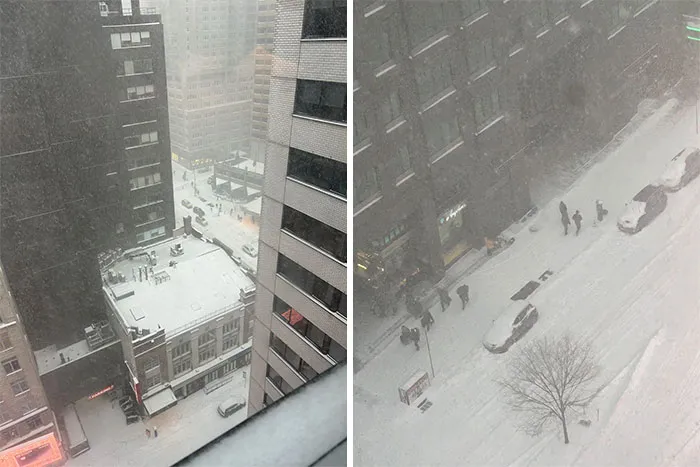 Snowstorm hitting a U.S. city with heavy snowfall covering streets, buildings, cars, and pedestrians navigating through the storm.