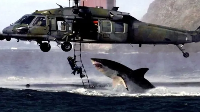 Helicopter rescue operation above ocean with a giant shark leaping out, an example of an internet photo that wasn’t what it seemed.