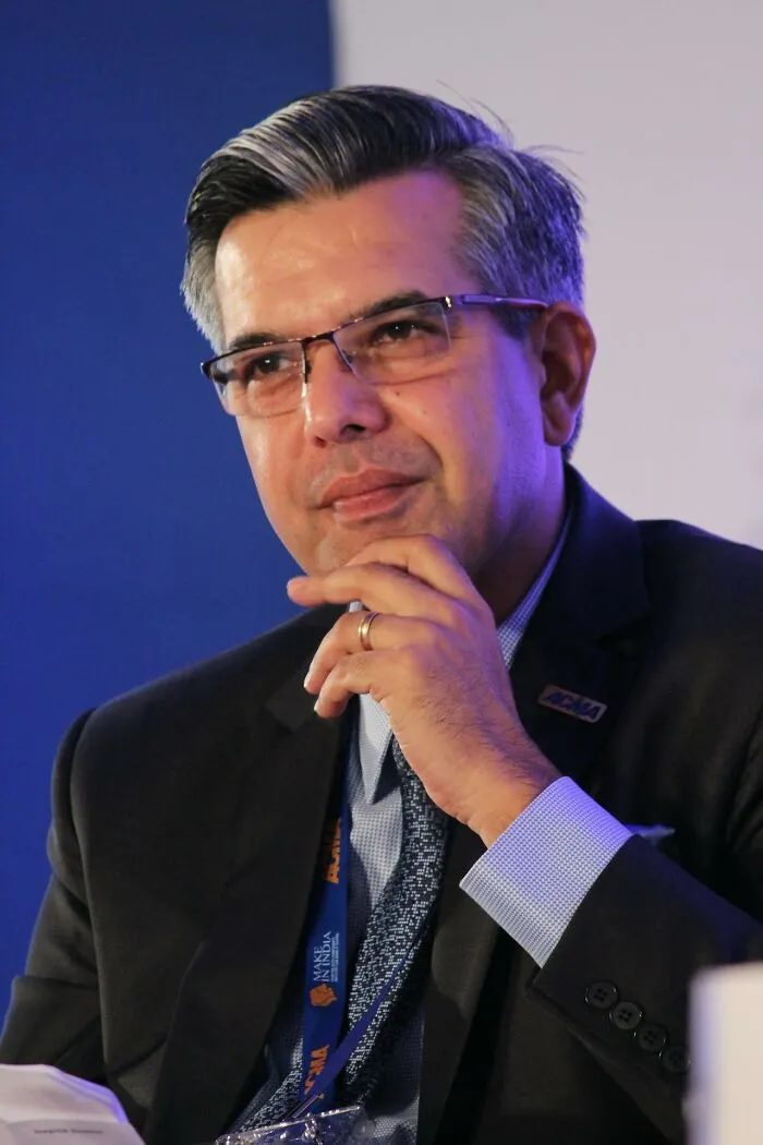 Man in suit and glasses, hand on chin, thoughtful expression illustrating creepiest displays of intelligence