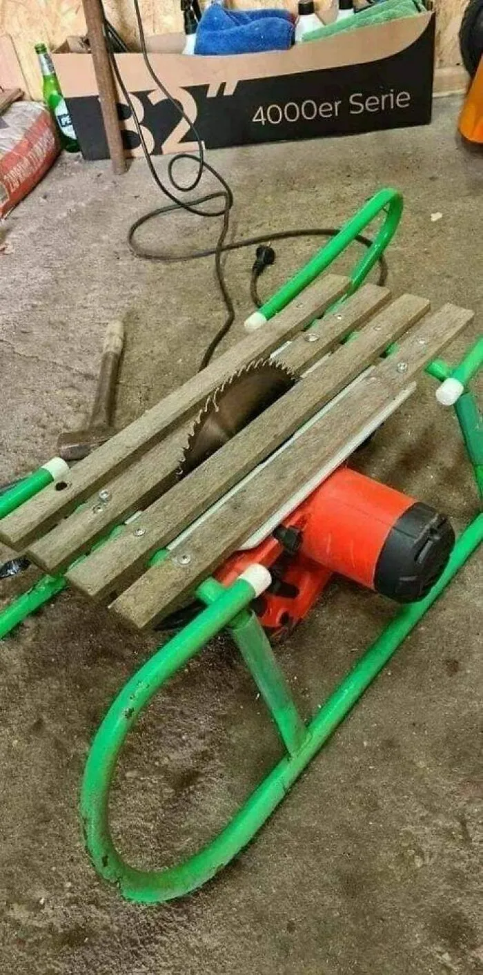Improvised table saw made from a green sled, wooden slats, and an electric saw motor, capturing the Eastern European experience humorously.