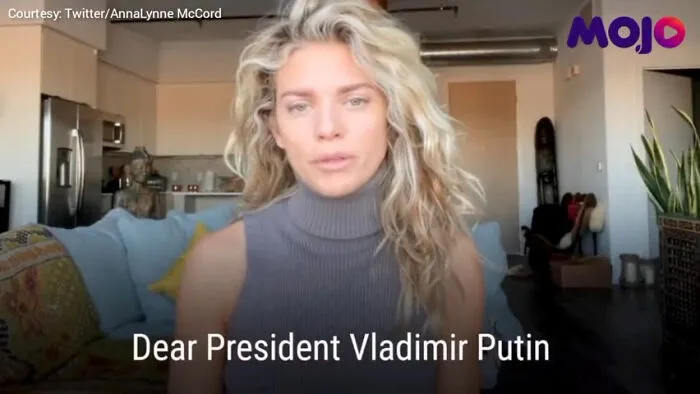 Blonde woman speaking in a casual home setting with text overlay referencing a cringe-worthy pop culture moment.