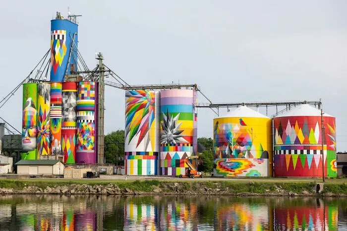 The “Shine Bright Saginaw Silo Mural Project” Involved Muralists Converting A Series Of Former Grain Silos Along The Saginaw Michigan Riverfront Into One Of North America’s Largest Public Artworks