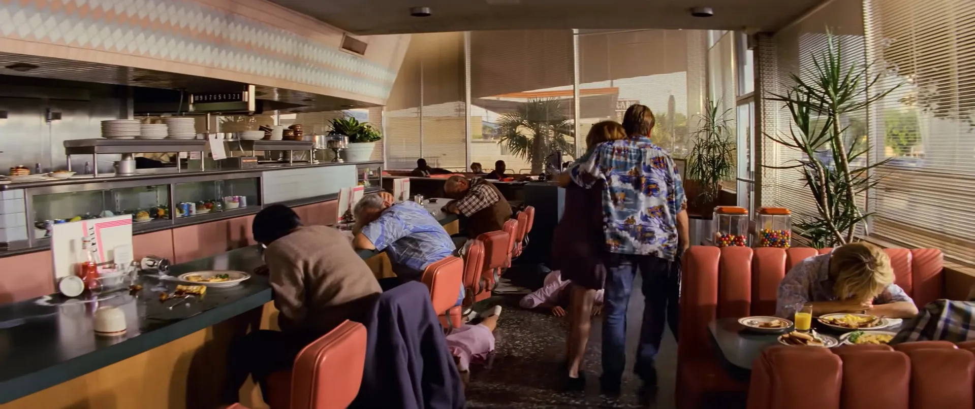Crowded diner final scene with patrons slumped over tables and a couple walking through in a movie final scenes quiz.