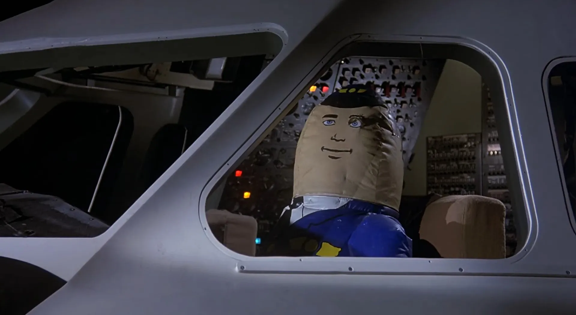 Inflatable pilot doll seated in a cockpit, depicting a movie final scene from a film ending mystery.
