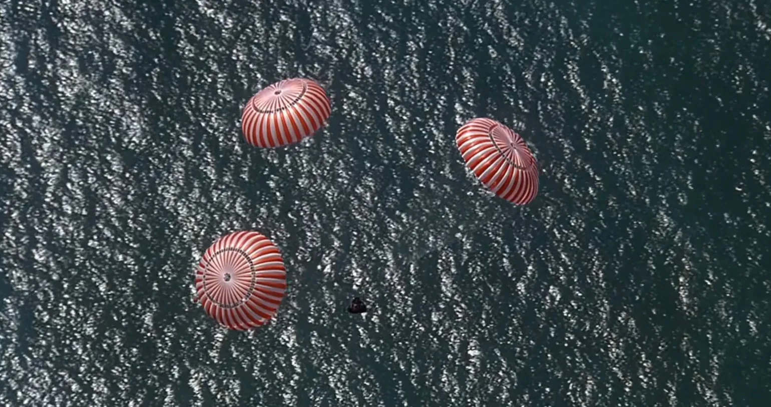 Parachutes descending over a body of water, depicting a dramatic final scene in a movie final scenes part 3.